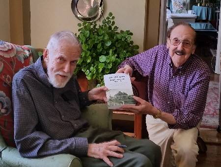 NRT President Lou Andrews presents the first book to author and town historian Harry Chase.